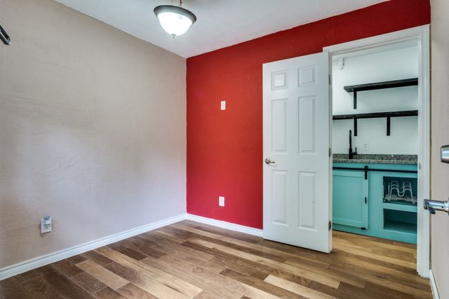 Unfurnished bedroom with wood finished floors and baseboards | Image 14