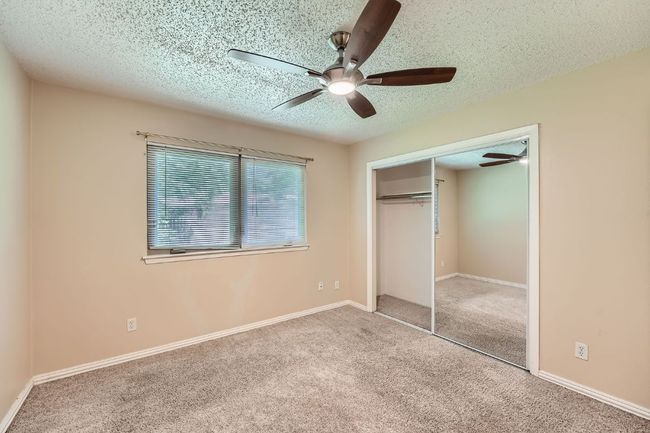 Primary bedroom offers great natural light and a ceiling fan with remote control. | Image 7