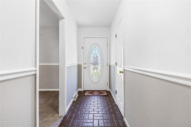 Doorway featuring brick floors and baseboards | Image 28