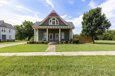 View of front of property with covered porch and a front yard | Image 1