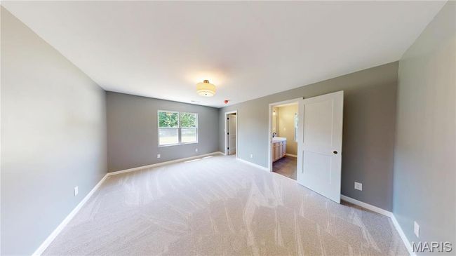 Unfurnished bedroom with carpet, baseboards, and connected bathroom | Image 13