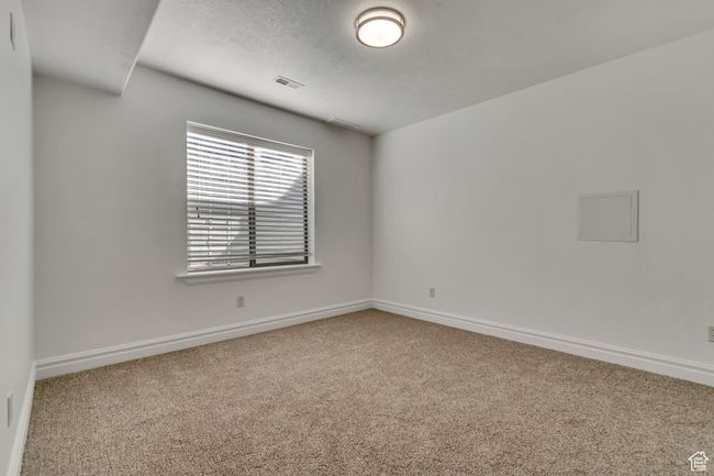 Unfurnished room with carpet and a textured ceiling | Image 32