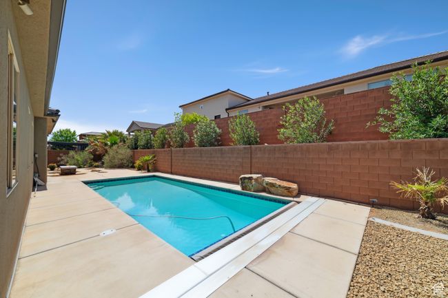 View of swimming pool with a patio area, a fenced backyard, and a fenced in pool | Image 29