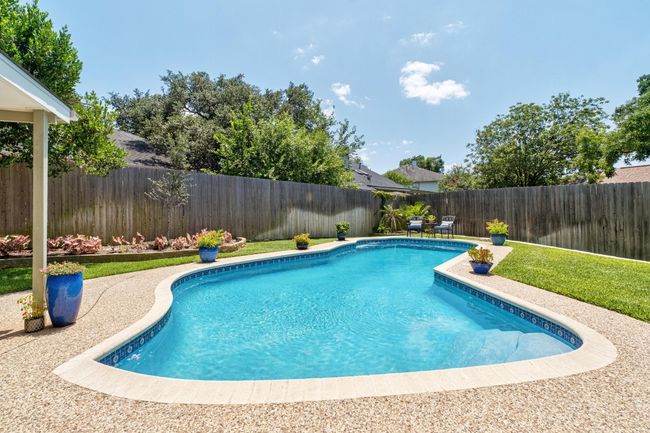 View of swimming pool featuring a fenced backyard | Image 26