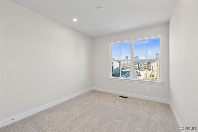 Empty room featuring baseboards, recessed lighting, visible vents, and light colored carpet | Image 17