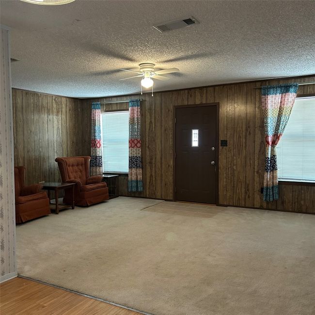 Bathroom with toilet, curtained shower, vanity, wood finished floors, and ceiling fan | Image 13