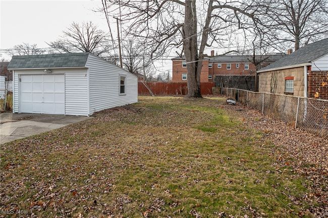 View of yard with an outbuilding, a detached garage, and driveway | Image 4