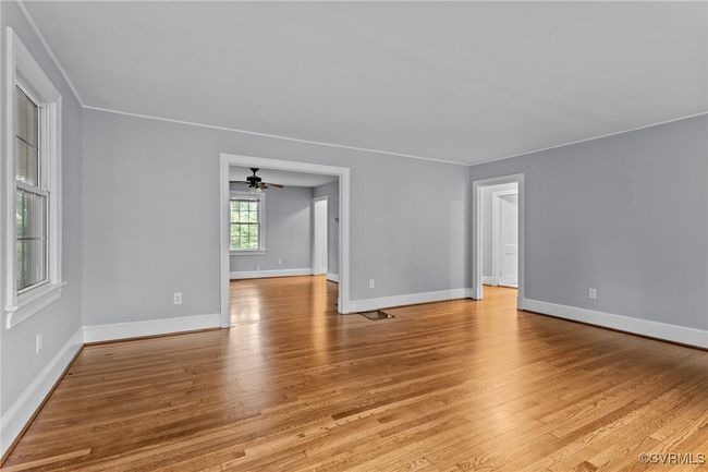 Unfurnished room featuring light wood-style floors, ceiling fan, and baseboards | Image 7