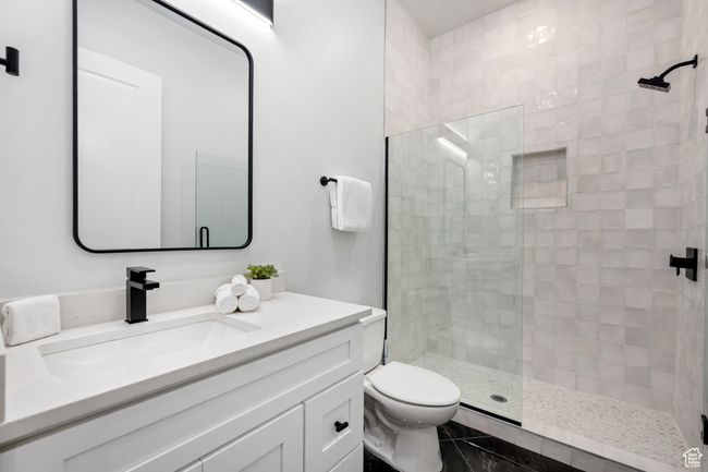 Bathroom featuring tile patterned flooring, toilet, vanity, and walk in shower | Image 13