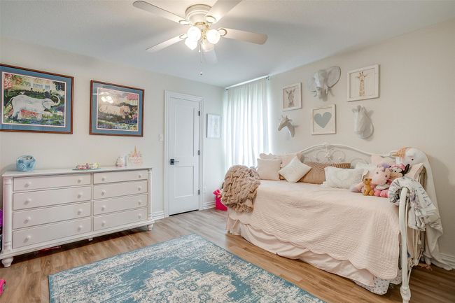 Bedroom with light wood-type flooring and ceiling fan | Image 26