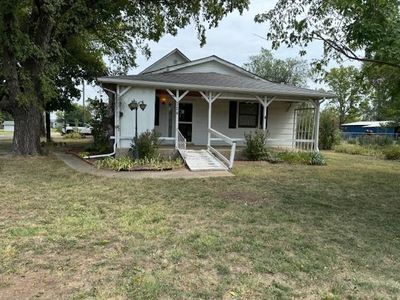 View of front of property featuring covered porch and a front lawn | Image 1