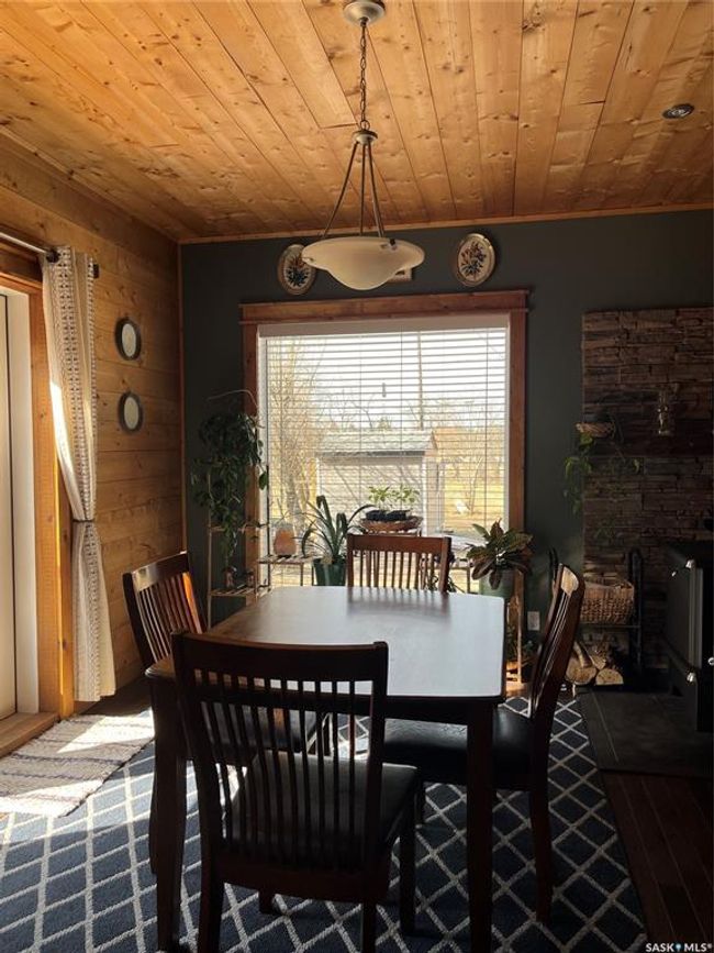 Dining area with wooden ceiling and wood walls | Image 18
