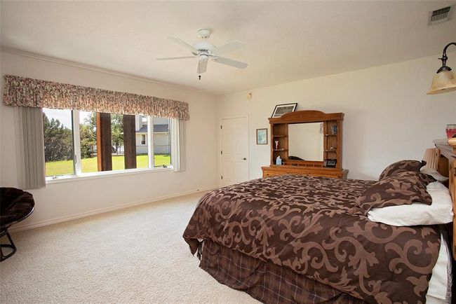 Carpeted bedroom with ceiling fan | Image 25