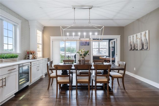 Sliding doors from Dining area to a covered deck with low maintenance floor and railing. Double glass doors open to Main Floor Home Office. | Image 14