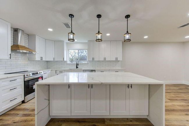 Kitchen Island wrapped in beautiful quartz also has storage! | Image 6