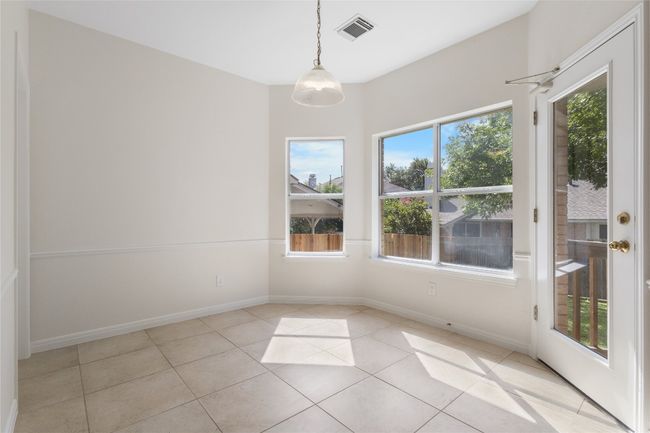 Unfurnished dining area featuring light tile patterned floors and baseboards | Image 11