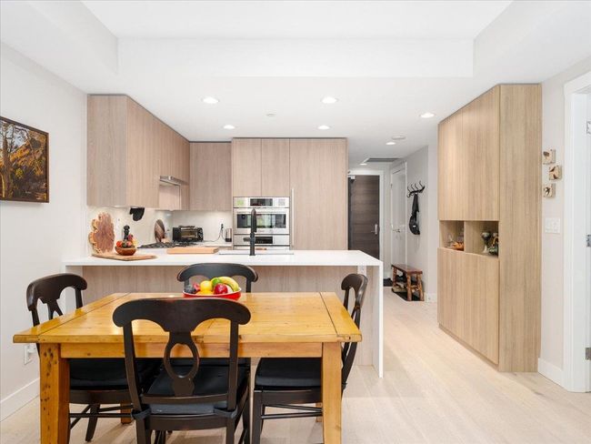 Kitchen featuring modern cabinets, stainless steel double oven, light brown cabinetry, and recessed lighting | Image 8