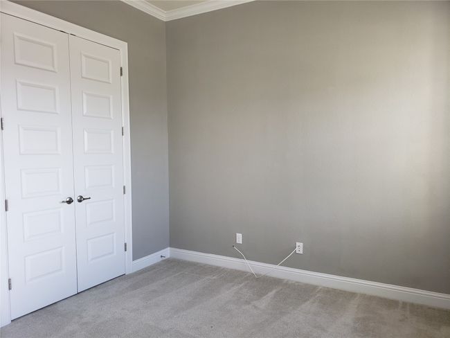 Unfurnished bedroom featuring carpet flooring, ornamental molding, and a closet | Image 11