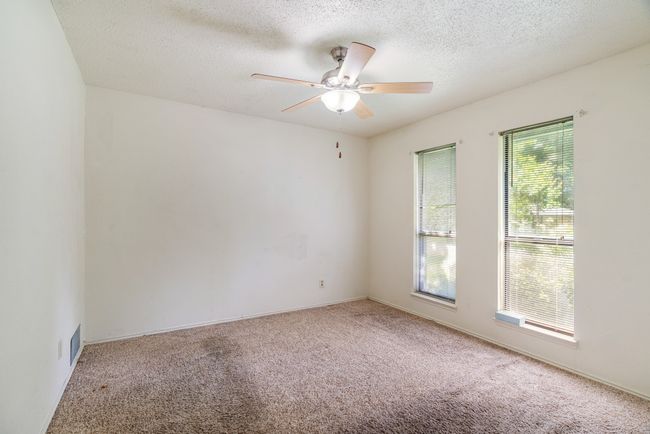 Spare room with carpet floors, ceiling fan, and a textured ceiling | Image 9