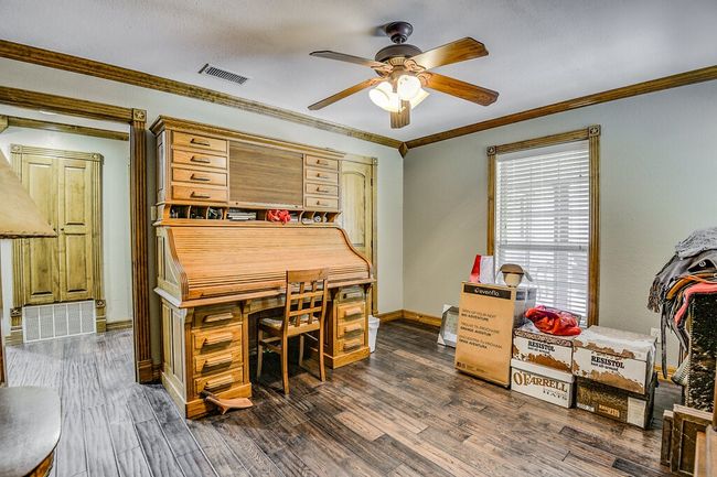 Office area with ceiling fan, dark wood-style floors, and ornamental molding | Image 17