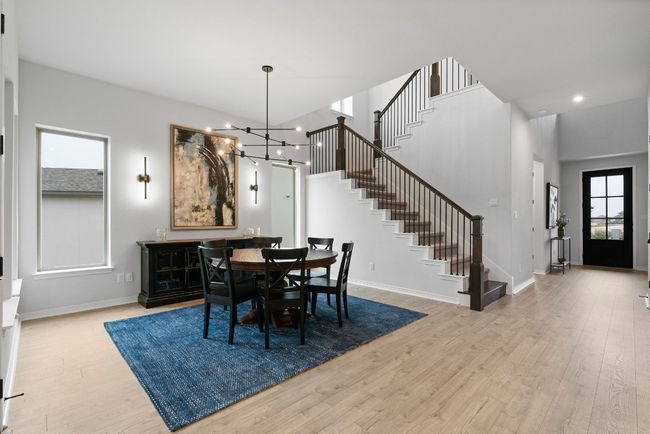 A look at the sun-filled dining area and its stylish overhead light fixture. | Image 15