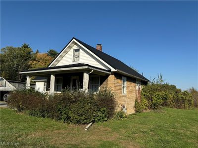 View of property exterior with a lawn | Image 2