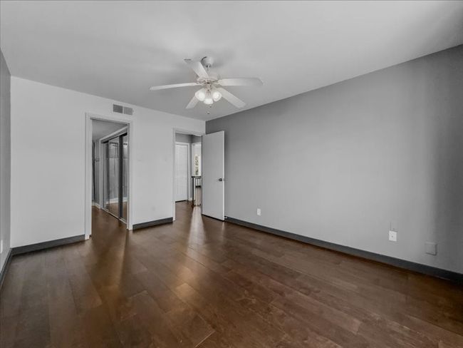 Upstairs bedroom featuring dark wood-type flooring and ceiling fan | Image 20