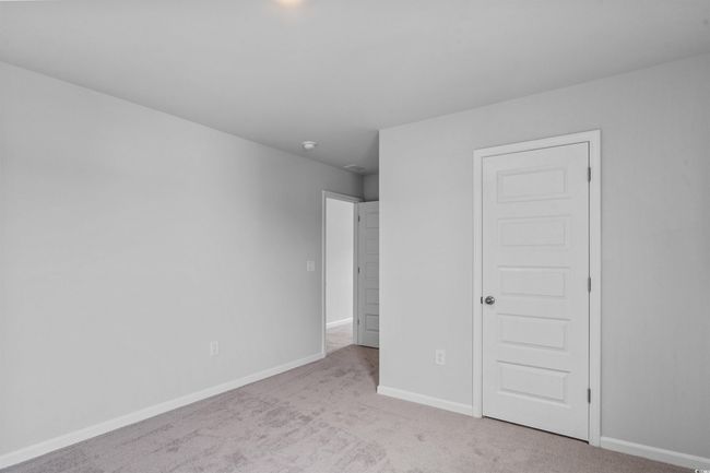 Carpeted spare room featuring baseboards and visible vents | Image 12