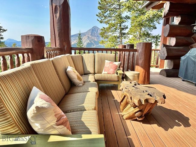 Covered portion of wrap around deck with summer view of Lone Mountain. | Image 87
