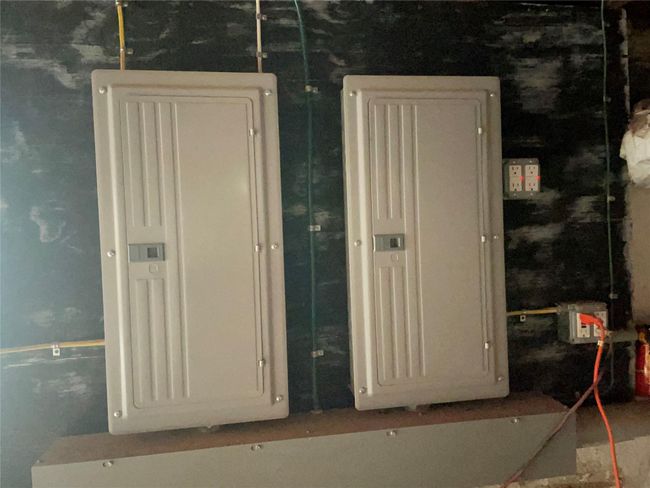 Utility room featuring new electric panel | Image 9