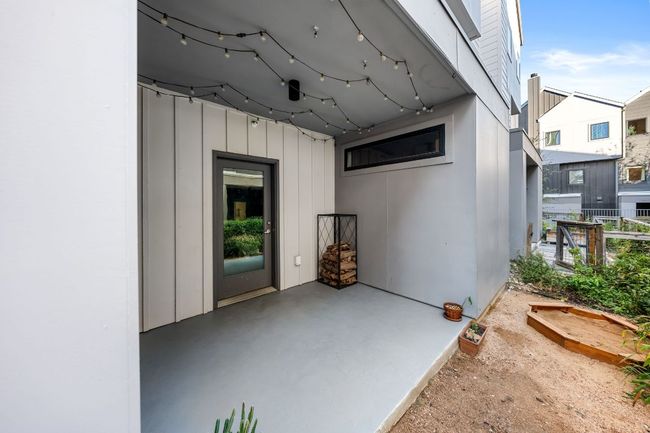 Property entrance with board and batten siding and a patio | Image 30