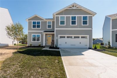 View of front facade featuring garage, central AC, and a front lawn | Image 1