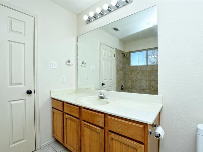 Full bathroom with visible vents, walk in shower, toilet, vanity, and tile patterned flooring | Image 17