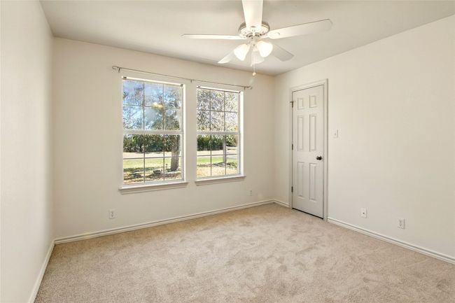 Spare room featuring ceiling fan, baseboards, and light carpet | Image 17
