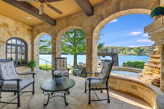 View of patio / terrace with an in ground hot tub, a water view, and a ceiling fan | Image 16