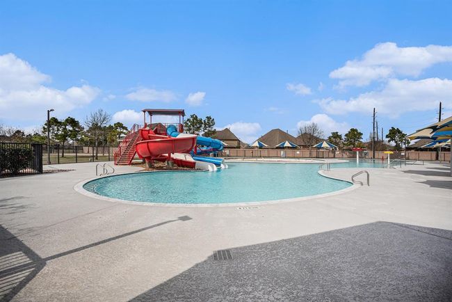 The expansive pool deck offers plenty of space to lounge under shaded umbrellas—perfect for soaking up the sun or enjoying poolside conversation. | Image 35