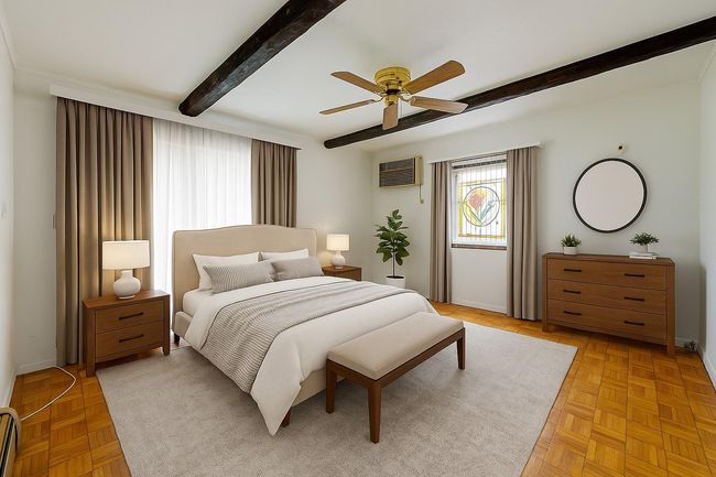 Bedroom featuring beam ceiling, ceiling fan, an AC wall unit, and a baseboard radiator | Image 18