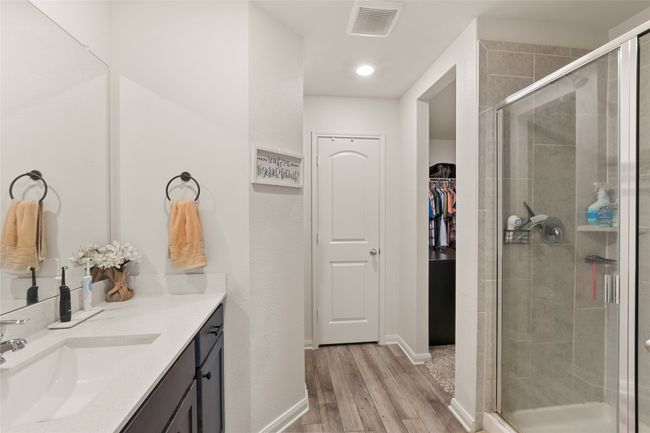 Bathroom featuring LVP flooring, an oversize shower, and vanity | Image 18