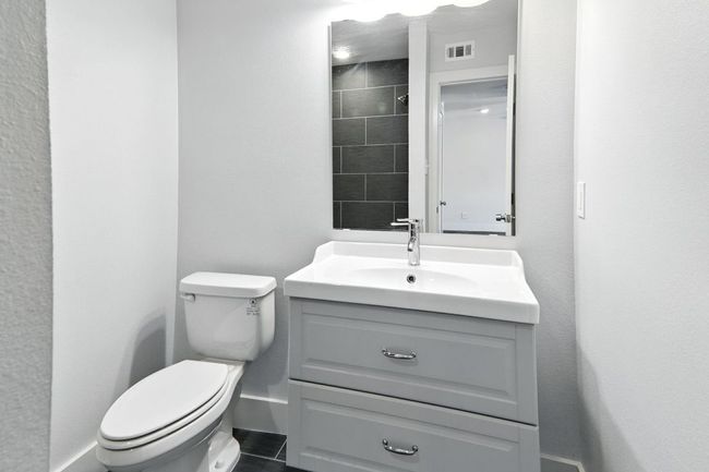 Bathroom with vanity and tiled shower | Image 14