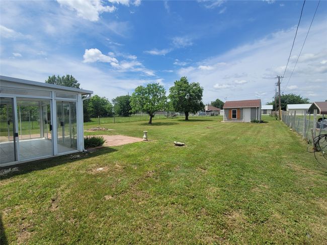 View of yard with a sunroom and an outbuilding | Image 25