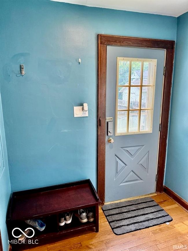 doorway to outside featuring wood finished floors and baseboards | Image 31