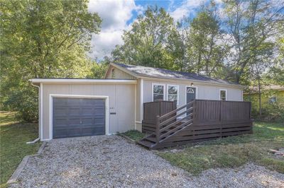 View of front of property featuring a deck and a garage | Image 2