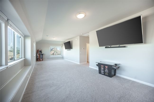 Unfurnished living room featuring carpet and vaulted ceiling | Image 20