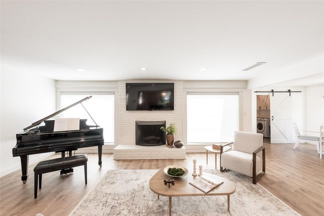 Two large picture windows that bring in a ton of natural light. Automatic blinds included for ease | Image 15