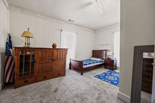 Carpeted bedroom featuring visible vents and a textured wall | Image 22