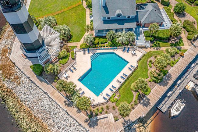 Aerial view of property and surrounding area with a pool area and a large body of water | Image 33