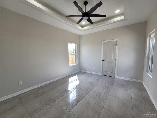 Unfurnished room featuring ceiling fan and a raised ceiling | Image 13