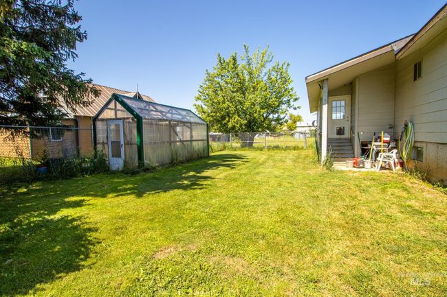 Fenced backyard featuring an exterior structure and an outbuilding | Image 8