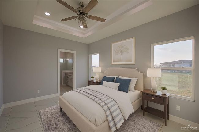 Bedroom featuring multiple windows, a raised ceiling, recessed lighting, connected bathroom, and a ceiling fan | Image 29
