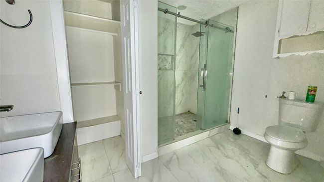 Bathroom with marble look tiles and a shower stall | Image 33